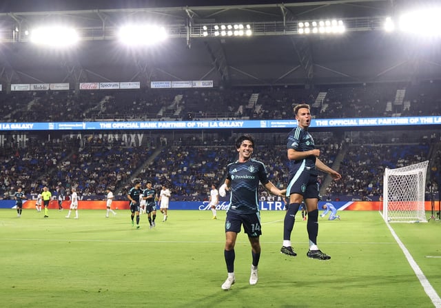 Paul Rothrock #14 and Danny Musovski #19 of the Seattle Sounders FC celebrate their third goal against LA Galaxy at Dignity Health Sports Park on August 10, 2025 in Carson, California.