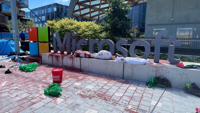 Protestors poured red paint over the Microsoft sign. 