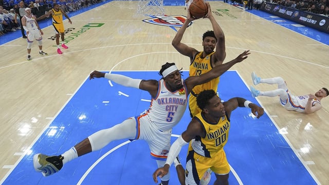 Jun 16, 2025; Oklahoma City, Oklahoma, USA; Indiana Pacers center Tony Bradley (13) rebounds over Oklahoma City Thunder guard Luguentz Dort (5) and Indiana Pacers guard Bennedict Mathurin (00) during the first half during game five of the 2025 NBA Finals at Paycom Center. Mandatory Credit: Nate Billings/Pool Photo via Imagn Images