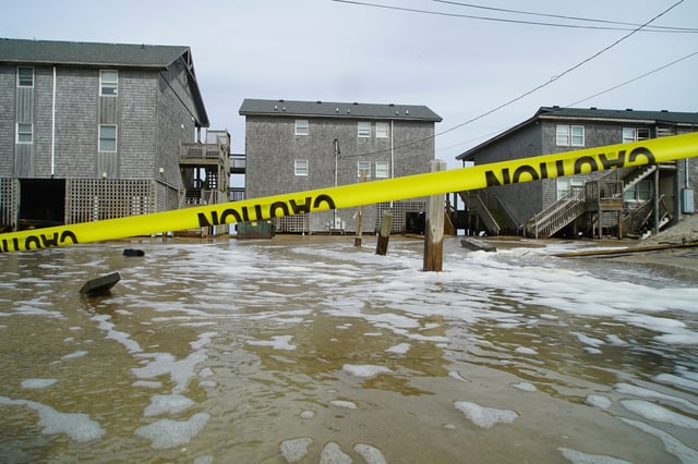 Sea water from Hurricane Erin surges under the Cape Hatteras Motel in Buxton, N.C., on Wednesday, Aug. 20, 2025. (AP Photo/Allen G. Breed)