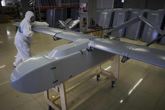 A worker inspects a combat drone at Fire Point's secret factory in Ukraine on Monday, Aug. 18, 2025. (AP Photo/Efrem Lukatsky)