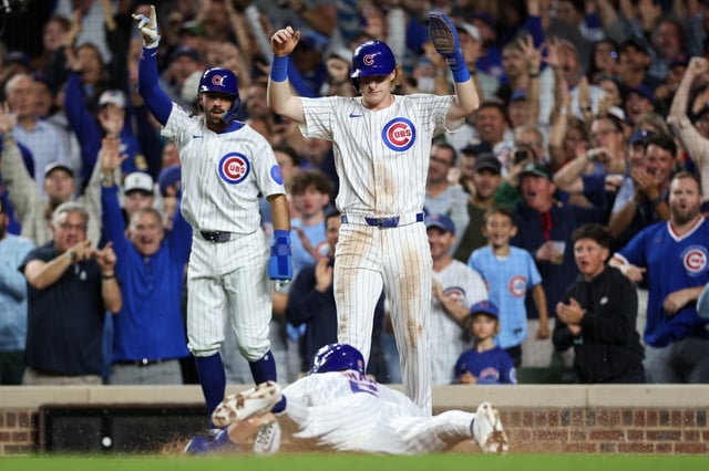 Chicago Cubs shortstop Dansby Swanson (7), Chicago Cubs outfielder Owen Caissie (19), and Chicago Cubs third baseman Matt Shaw (6) score off a three-RBI double from Chicago Cubs first baseman Michael Busch (29) during the third inning against the Milwaukee Brewers at Wrigley Field on Wednesday, Aug. 20, 2025, in Chicago. (Armando L. Sanchez/Chicago Tribune)
