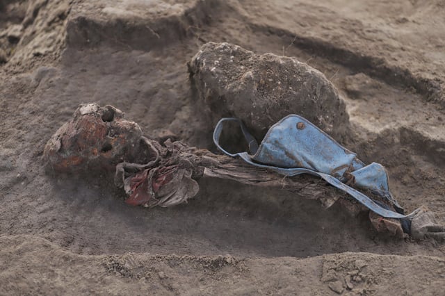 An exhumed human skeleton is seen with a school bag at the site of a mass grave in Chemmani, Sri Lanka, June 28, 2025. (AP Photo/Kanapathipillai Kumanan)