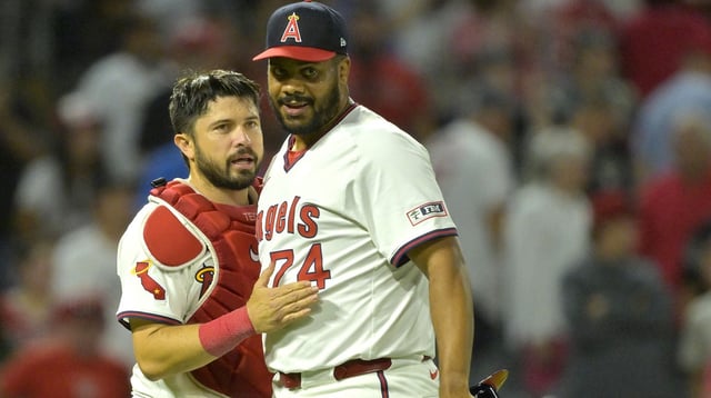Jul 9, 2025; Anaheim, California, USA; Los Angeles Angels relief pitcher Kenley Jansen (74) is congratulated by catcher Travis d'Arnaud (25) after his 16th save of the season during the ninth inning against the Texas Rangers at Angel Stadium. Mandatory Credit: Jayne Kamin-Oncea-Imagn Images