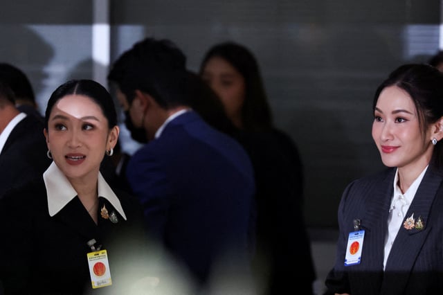 Suspended Thai Prime Minister Paetongtarn Shinawatra stands next to her sister Pintongtha Kunakornwong as she arrives at the Constitutional Court to testify in a high-profile ethics case, following a leaked phone conversation between her and Cambodia’s former leader Hun Sen, in Bangkok, Thailand, August 21, 2025. REUTERS/Athit Perawongmetha REFILE - CORRECTING NAME OF SUSPENDED THAI PRIME MINISTER FROM "PINTONGTHA KUNAKORNWONG" TO "PAETONGTARN SHINAWATRA".