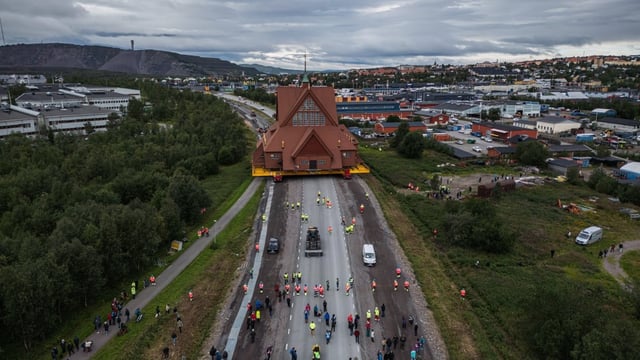 The Kiruna Church moves 0.5 kilometres an hour down a street that was widened for its journey.      