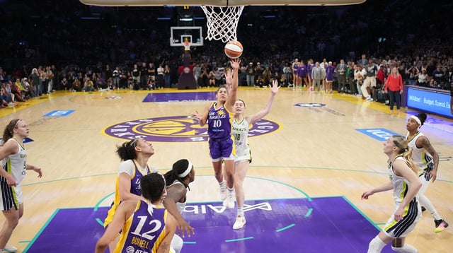 Aug 20, 2025; Los Angeles, California, USA; LA Sparks guard Kelsey Plum (10) scores with no time remaining against Dallas Wings center Luisa Geiselsoder (18) for the game-winning basket at Crypto.com Arena. Mandatory Credit: Kirby Lee-Imagn Images