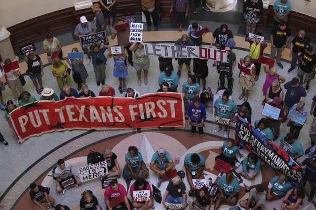 Protesters gather in the rotunda outside the House Chamber at the Texas Capitol as lawmakers debate a redrawn U.S. congressional map in Texas during a special session, Wednesday, Aug. 20, 2025, in Austin, Texas. (AP Photo/Eric Gay)