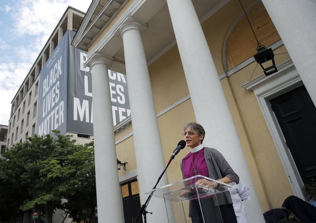 FILE - The Rev. Mariann Budde, bishop of Washington's Episcopal diocese, speaks during a service outside St. John's Episcopal Church near the White House in Washington, on June 19, 2020, with a Black Lives Matter banner in the background. (AP Photo/Carolyn Kaster, File)