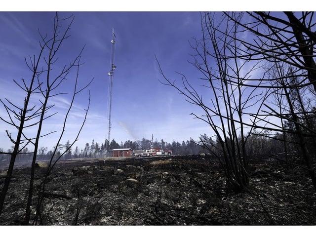 Fire crews protect a communications tower from the Long Lake wildfire in West Dalhousie. 