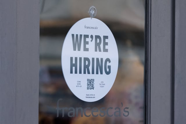 A "we're hiring" sign is displayed on the door of a local business, after U.S. employment growth slowed more than expected in July, in Encinitas, California, U.S. August 1, 2025.   REUTERS/Mike Blake/File Photo