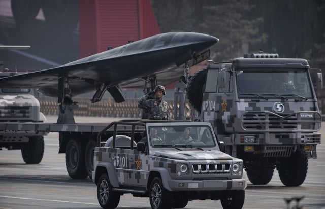 A soldier salutes in front of a drone during a parade to celebrate the 70th Anniversary of the founding of the People's Republic of China at Tiananmen Square in 1949, on October 1, 2019, in Beijing, China.
