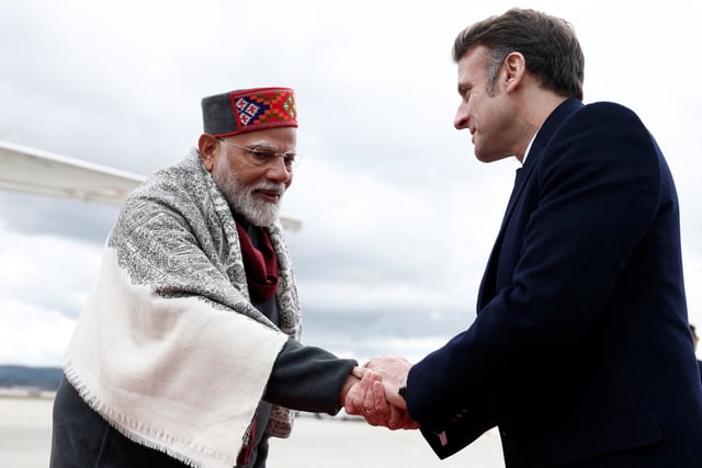 French President Emmanuel Macron shakes hands with Indian Prime Minister Narendra Modi after a departure ceremony at Marseille Provence airport in Marignane as part of a visit in Marseille, France, February 12, 2025.  REUTERS/Christian Hartmann/Pool/File Photo