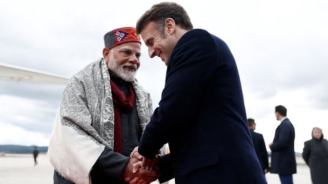 French President Emmanuel Macron shakes hands with Prime Minister Narendra Modi
