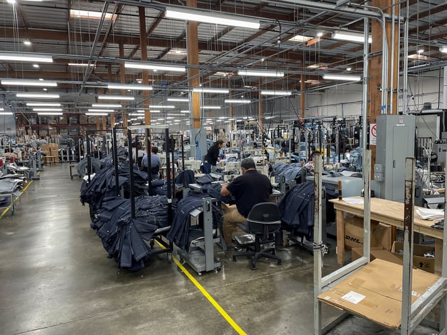 People work at Saitex's factory, which experiments with new robots to cut the cost of making blue jeans, in Los Angeles, California, U.S. September 21, 2022. REUTERS/Timothy Aeppel/File Photo