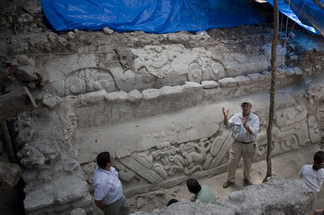 FILE - U.S. archaeologist Richard Hansen, right, shows a limestone frieze found at El Mirador, a Mayan archaeological site, northern Guatemala, March 7, 2009. (AP Photo/Moises Castillo, File)