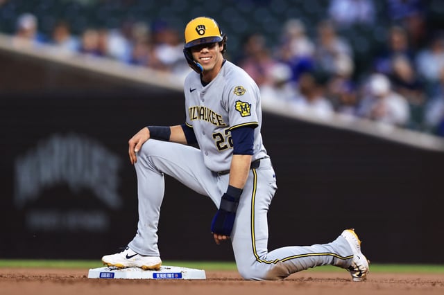 CHICAGO, ILLINOIS - AUGUST 19: Christian Yelich #22 of the Milwaukee Brewers slides into second base after a hit by Andrew Vaughn during the first inning against the Chicago Cubs in game 2 of a double header at Wrigley Field on August 19, 2025 in Chicago, Illinois.
