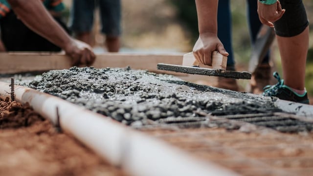 Workers placing concrete.