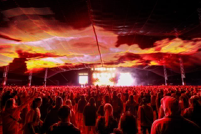 READING, ENGLAND - AUGUST 25: (EDITORIAL USE ONLY) Festival goers watch Skrillex perform live on the Chevron stage during day three of Reading Festival 2024 at Richfield Avenue on August 25, 2024 in Reading, England. (Photo by Simone Joyner/Getty Images)