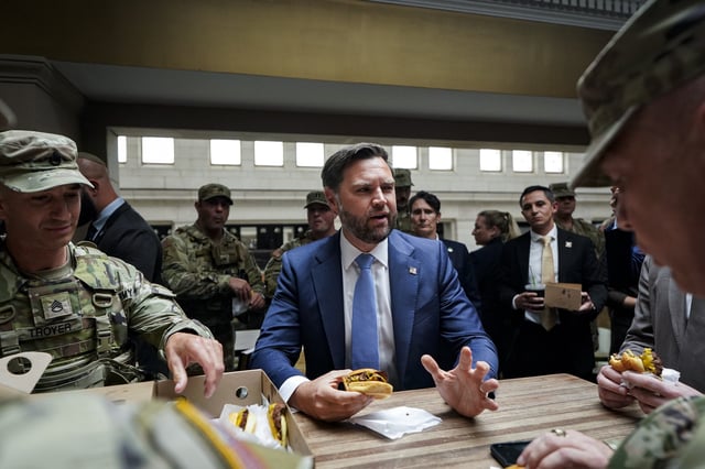 US vice president JD Vance eats a Shake Shack hamburger with members of the National Guard during a visit to Union Station on 20 August 20, 2025. (Al Drago-Pool/Getty Images)