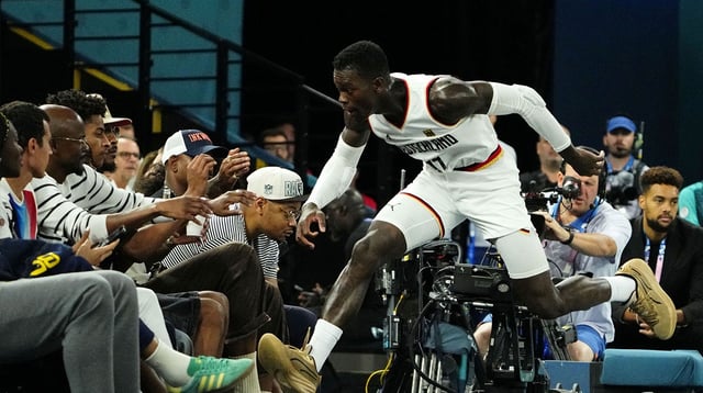 Aug 10, 2024; Paris, France; Germany point guard Dennis Schroder (17) jumps towards the seat after making a play for the ball against Serbia in the men's basketball bronze medal game during the Paris 2024 Olympic Summer Games at Accor Arena. Mandatory Credit: Rob Schumacher-USA TODAY Sports
