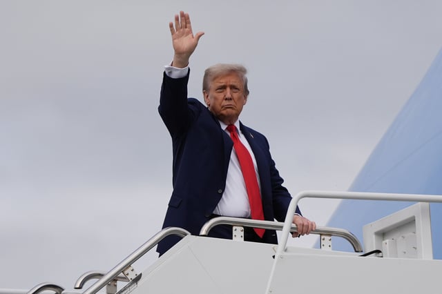 President Donald Trump waves as he boards Air Force One after meeting with Russia's President Vladimir Putin at Joint Base Elmendorf-Richardson, Alaska, Friday, Aug. 15, 2025.