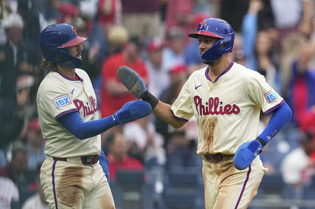 PHILADELPHIA, PENNSYLVANIA - AUGUST 20: Trea Turner #7 of the Philadelphia Phillies celebrates with Bryson Stott #5 after scoring a run in the bottom of the seventh inning against the Seattle Mariners at Citizens Bank Park on August 20, 2025 in Philadelphia, Pennsylvania. The Phillies defeated the Mariners 11-2.