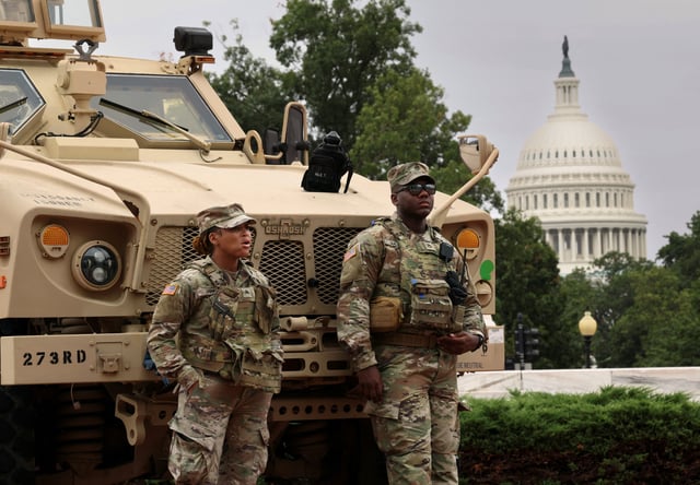 With the dome of the U.S. Capitol in the background, members of the DC National Guard keep watch outside Union Station after U.S. President Donald Trump deployed the National Guard and ordered an increased federal law enforcement presence to assist in crime prevention, in Washington, D.C., August 19, 2025. REUTERS/Kevin Lamarque/File Photo