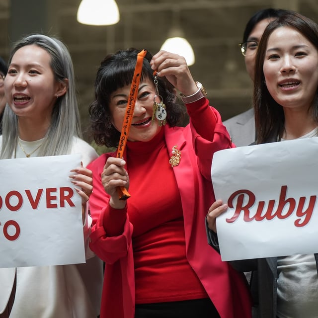 Billionaire Ruby Liu, centre, poses with her staff while holding a set of keys to a former Hudson's Bay-owned Saks Off 5th department store during a "handover ceremony" at Tsawwassen Mills shopping mall that she owns, in Tsawwassen, B.C., on Thursday, June 26, 2025. THE CANADIAN PRESS/Darryl Dyck