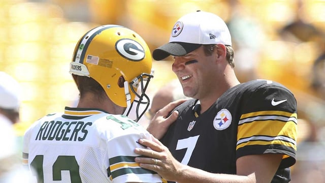 Aug 23, 2015; Pittsburgh, PA, USA; Green Bay Packers quarterback Aaron Rodgers (12) and Pittsburgh Steelers quarterback Ben Roethlisberger (7) talk at mid-field before their game at Heinz Field. Mandatory Credit: Charles LeClaire-Imagn Images