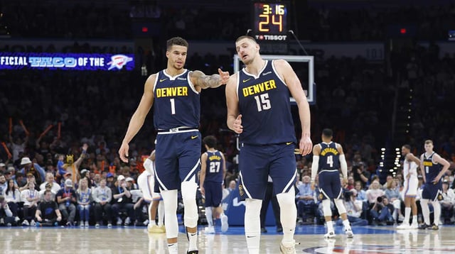 Mar 10, 2025; Oklahoma City, Oklahoma, USA; Denver Nuggets forward Michael Porter Jr. (1) and center Nikola Jokic (15) talk during a time out against the Oklahoma City Thunder during the second half at Paycom Center. Mandatory Credit: Alonzo Adams-Imagn Images
