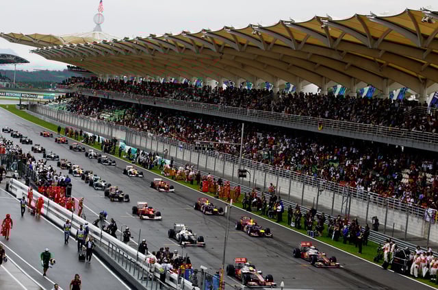 The field waits to restart following a rain delay during the Malaysian Formula One Grand Prix at the Sepang Circuit on March 25, 2012 in Kuala Lumpur, Malaysia.