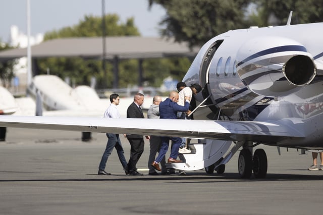 Harjinder Singh is escorted to an airplane by Florida Lt. Gov. Jay Collins and law enforcement on Thursday, Aug. 21, 2025, in Stockton, Calif. (AP Photo/Benjamin Fanjoy)