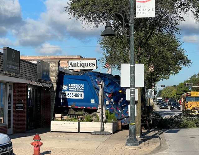 A recycling truck crashed into a small business in the 1000 block of East 31st Street about 8 a.m. Thursday, Aug. 21, in La Grange Park, destroying windows, ceiling boards and decades-old heirlooms. (Dan Petrella/Chicago Tribune)