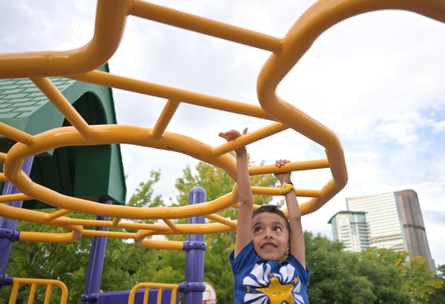 Five-year-old Urysohn Streit plays on the playground equipment outside Polaris Elementary in Denver on Aug. 19, 2024. Urysohn will be starting 1st grade this year. He and many other Denver Public School students headed back to the classroom today for the first day of school. (Photo by RJ Sangosti/The Denver Post)