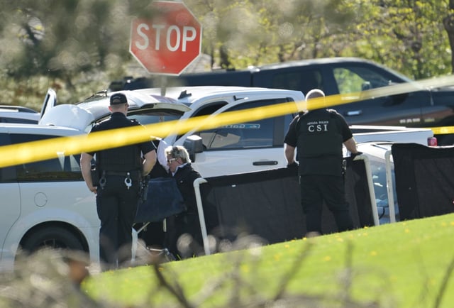 The body of one of two suspects is loading into the coroner's van after they were shot and killed at the intersection of 2nd Avenue and Garrison Street in Lakewood, Colorado, on April 30, 2024. Thornton police had initiated pursuit of the suspects in a vehicle lacking license plates, trailing them for several miles before they crossed into Lakewood. According to police reports, one individual in the pursued vehicle disembarked and fired shots at Thornton officers. Subsequently, both suspects exited the vehicle, with one brandishing a firearm. Law enforcement officers responded by fatally shooting both suspects. (Photo by RJ Sangosti/The Denver Post)