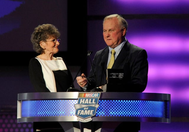 Humpy Wheeler presents Francis Flock, widow of NASCAR Sprint Cup Series driver Tim Flock, with the hall of fame ring after he is inducted to the Hall of Fame during the NASCAR hall of fame induction ceremony at NASCAR Hall of Fame.