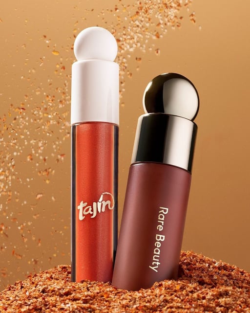 Selena Gomez's beauty brand Rare Beauty and Tajín have released a Cheek & Lip Set. Available on the Rare Beauty and Sephora websites, the set includes a Soft Pinch Liquid Blush in Chamoy (red brown) and Positive Light Luminizing Lip Gloss in Clásico (terracotta with copper and gold shimmer).