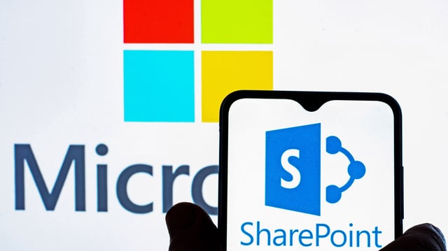 The SharePoint logo on a phone, with the Microsoft logo in the background.
