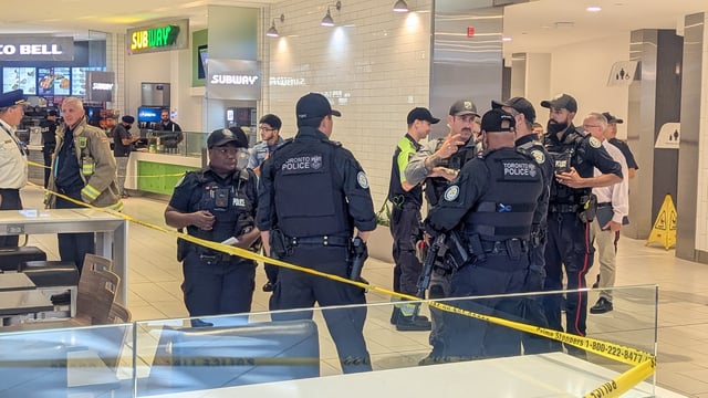 Toronto police officers attend the scene of a homicide inside the Scarborough Town Centre on Aug. 21, 2025.