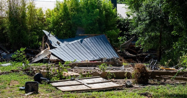 A fallen roof and debris is seen on the banks of the Guadalupe River after intense flooding Tuesday July 8, 2025 in Ingram, Texas.