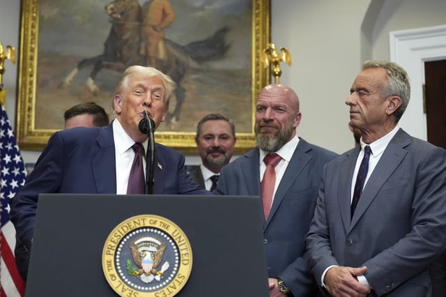 President Donald Trump, from left, speaks as Cody Campbell, WWE CCO Triple H and Health and Human Services Secretary Robert F. Kennedy Jr. listen during an event for the signing of an executive order restarting the Presidential Fitness Test in public schools, Thursday, July 31, 2025, in the Roosevelt Room of the White House in Washington. (AP Photo/Jacquelyn Martin)
