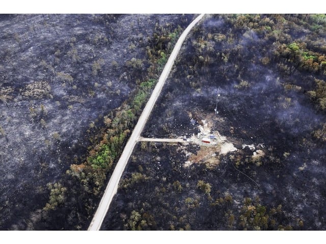  A communications tower being protected from the Long Lake wildfire is, surrounded by burned forest, in West Dalhousie.