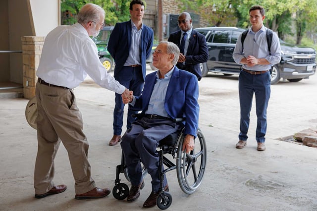 Kerrville Mayor Joe Herring Jr. welcomes Gov. Greg Abbott as he arrives at Louise Hays Park in Kerrville on Thursday.