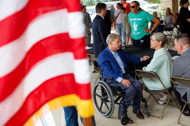 Gov. Greg Abbott talks with Hunt ISD Superintendent Luci Harmon after a news conference at Louise Hays Park in Kerrville on Thursday. The Community Foundation of the Texas Hill Country announced it will allocate $40 million to a housing fund as part of its recovery plan following the July 4 floods.