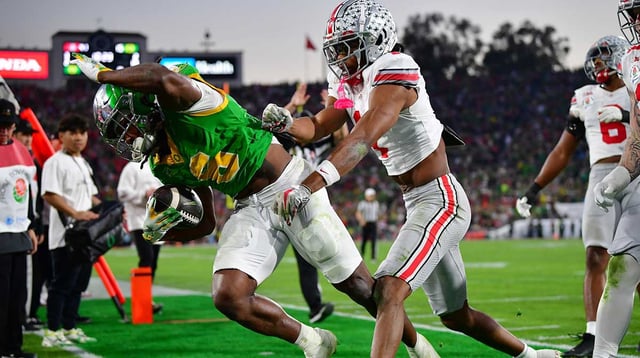 Ohio State Buckeyes cornerback Davison Igbinosun (1) pushes Oregon Ducks running back Noah Whittington (6) out of bounds in the second half in the 2025 Rose Bowl college football quarterfinal game at Rose Bowl Stadium. Mandatory Credit: Gary A. Vasquez-Imagn Images