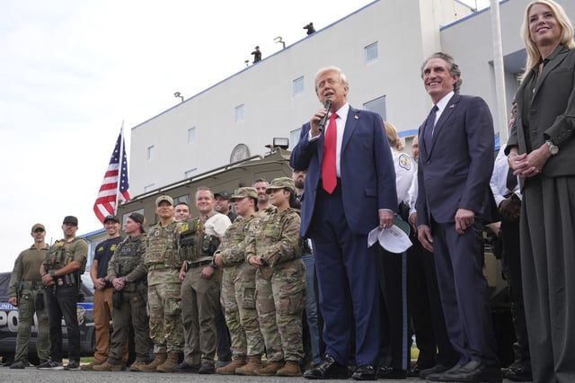 President Donald Trump speaks with members of law enforcement and National Guard soldiers, Thursday, Aug. 21, 2025, in Washington, as Interior Secretary Doug Burgum and Attorney General Pam Bondi listen. (AP Photo/Jacquelyn Martin)