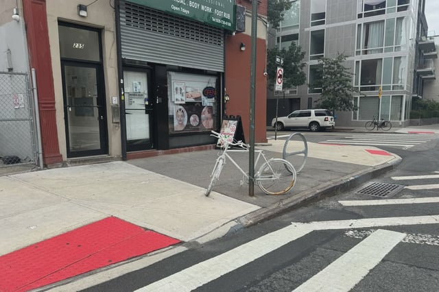 A ghost bike marking where a cyclist was killed on McGuinness Boulevard.