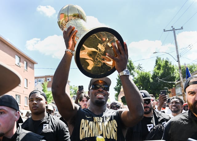 Oklahoma City Thunder guard Luguentz Dort, centre, carries the NBA's Larry O'Brien trophy through the streets of Montreal North, Thursday, Aug. 21, 2025. THE CANADIAN PRESS/Graham Hughes