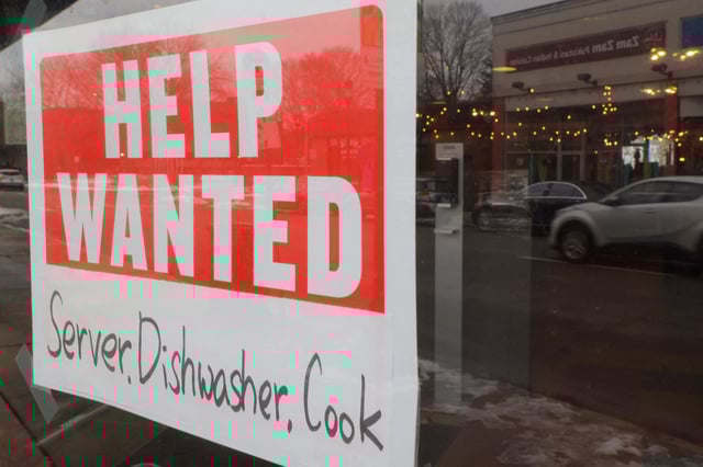 A “Help Wanted” sign hangs in restaurant window in Medford, Massachusetts in January 2023.